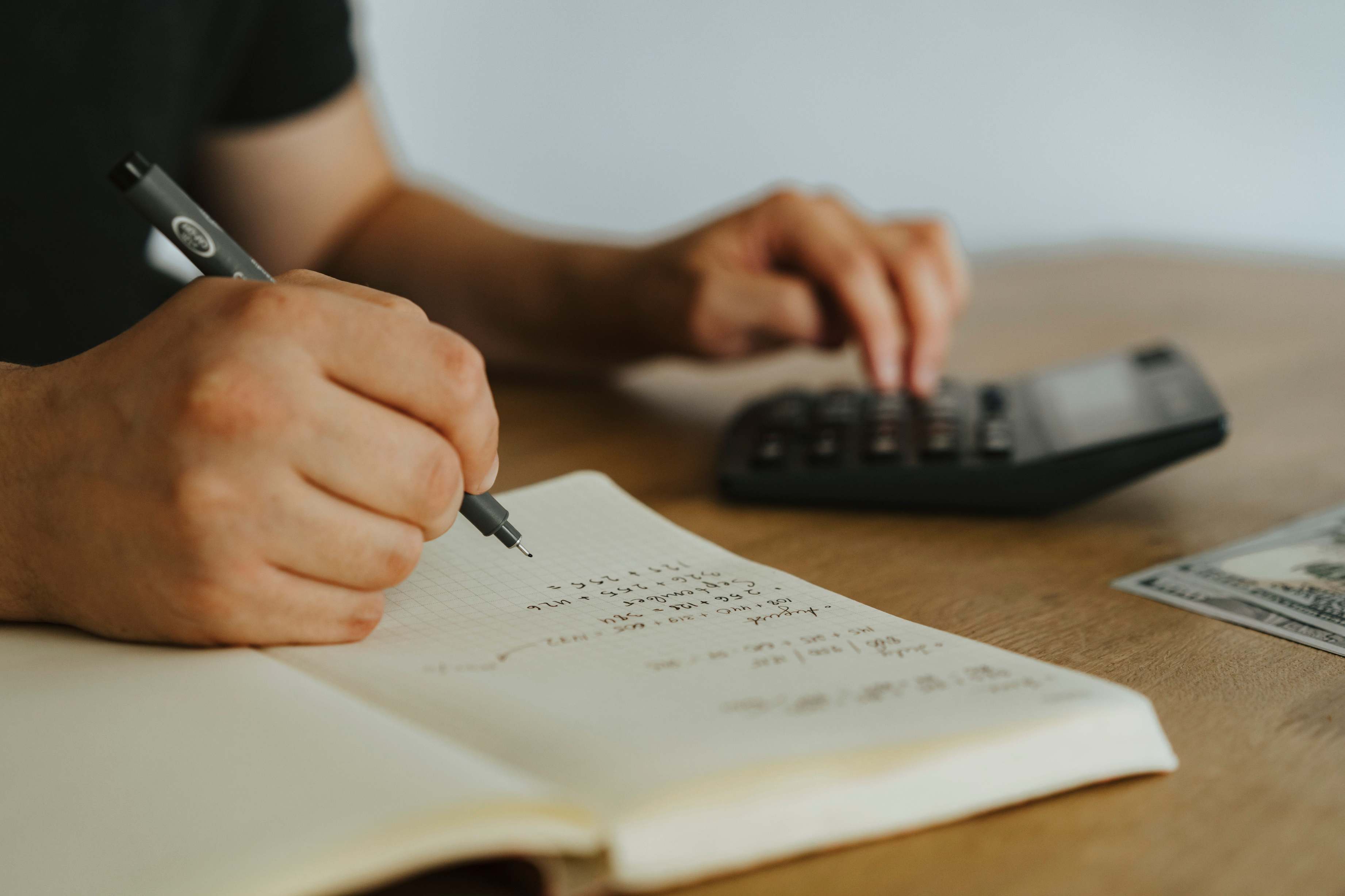 Notizblock und Taschenrechner bei Finanznotizen, hands writing notebook